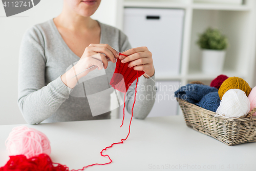 Image of woman hands knitting with needles and yarn