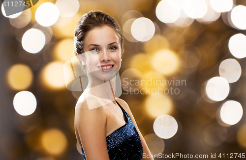 Image of smiling woman in evening dress and pearl earring