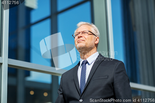 Image of senior businessman on city street