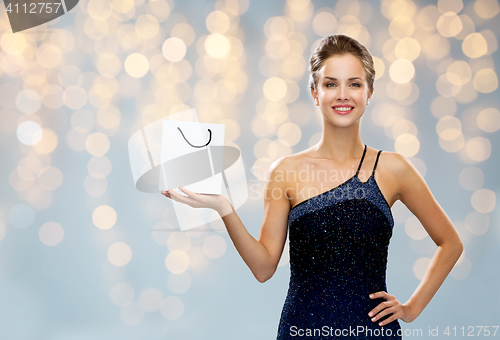 Image of smiling woman with white blank shopping bag