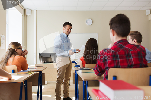 Image of group of students and teacher with test results