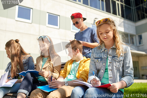 Image of group of students with notebooks at school yard