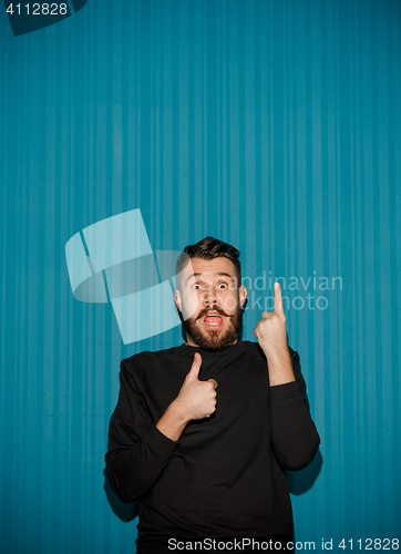 Image of Portrait of young man with shocked facial expression