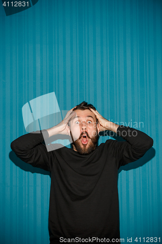 Image of Portrait of young man with shocked facial expression