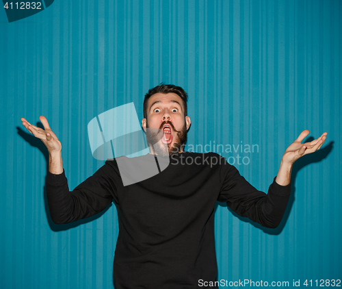 Image of Portrait of young man with shocked facial expression