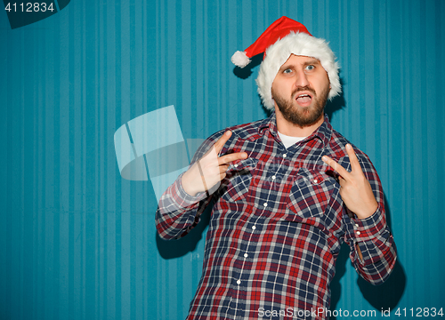 Image of The opinionated christmas man wearing a santa hat