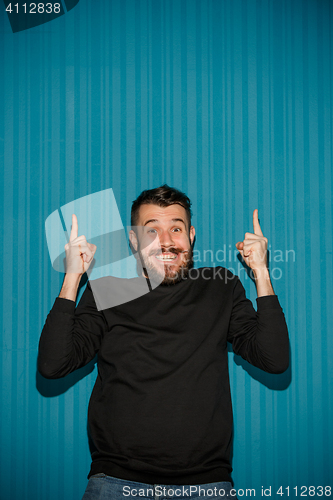 Image of Portrait of young man with shocked facial expression