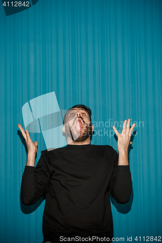 Image of Portrait of young man with shocked facial expression