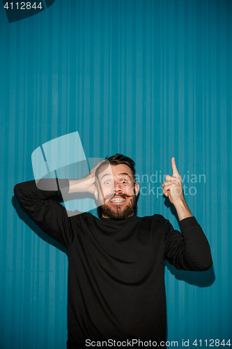 Image of Portrait of young man with shocked facial expression