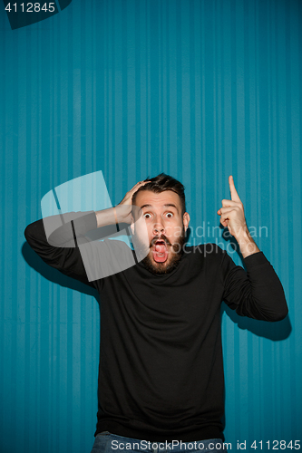 Image of Portrait of young man with shocked facial expression