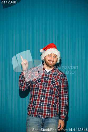 Image of Smiling christmas man wearing a santa hat