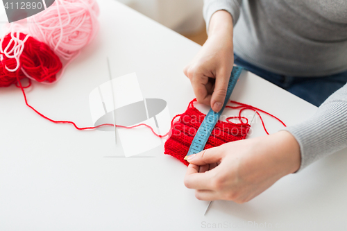 Image of woman with knitting, needles and measuring tape