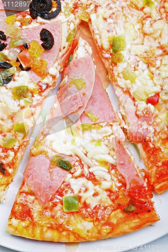 Image of Slice of ham pizza on plate