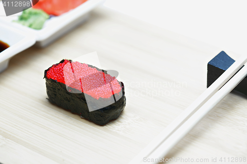 Image of Tobiko sushi on wood