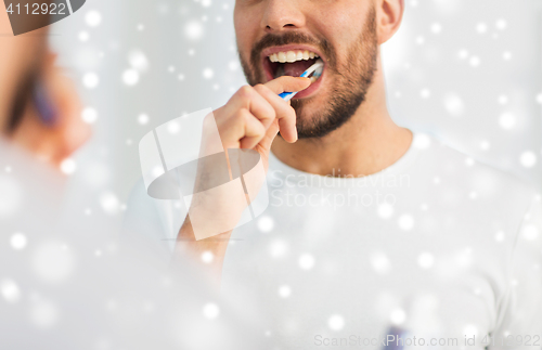 Image of close up of man with toothbrush cleaning teeth