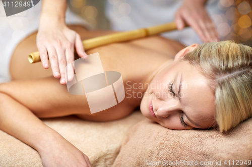 Image of close up of woman lying and having massage in spa