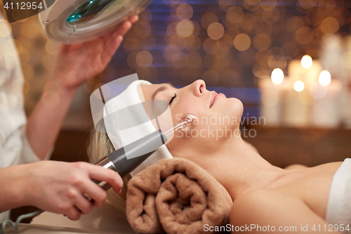 Image of close up of young woman having face massage in spa