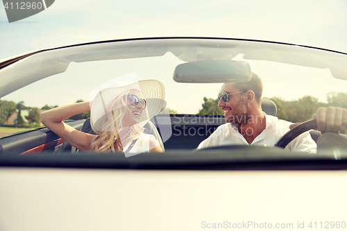 Image of happy man and woman driving in cabriolet car