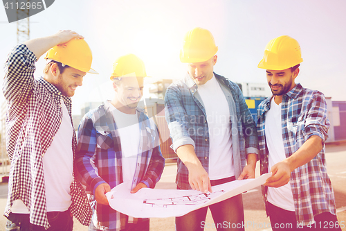 Image of group of builders with tablet pc and blueprint