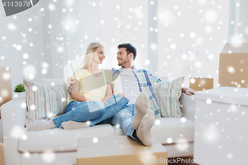 Image of happy couple with big cardboard boxes at new home