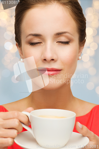 Image of close up of woman in red with coffee cup 