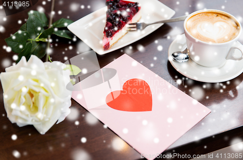 Image of close up of greeting card with heart and coffee