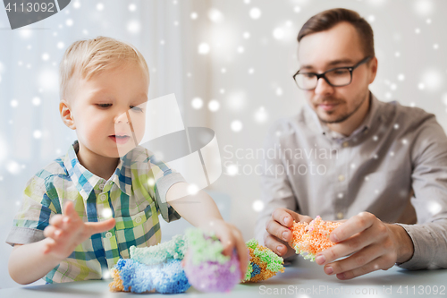 Image of father and son playing with ball clay at home