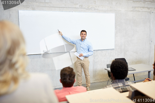 Image of group of students and teacher at lecture