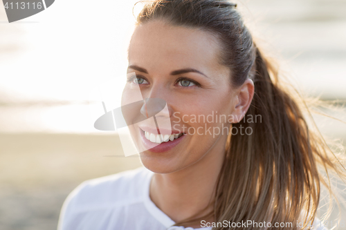 Image of happy young woman face on beach