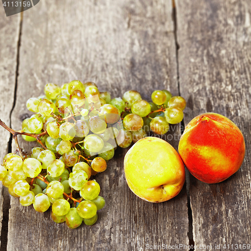 Image of Two peaches and grape