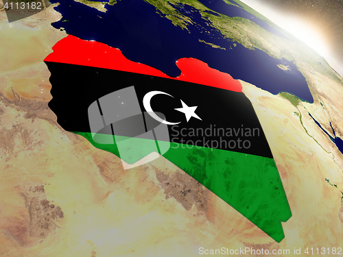 Image of Libya with flag in rising sun
