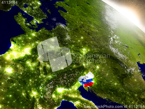 Image of Slovenia with flag in rising sun