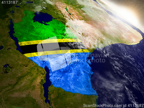 Image of Tanzania with flag in rising sun