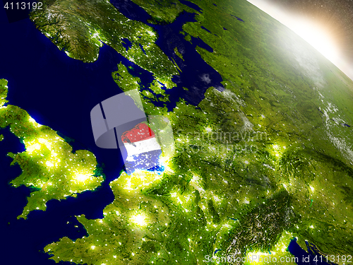 Image of Netherlands with flag in rising sun