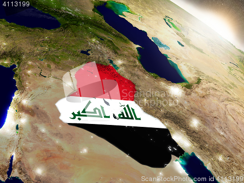 Image of Iraq with flag in rising sun