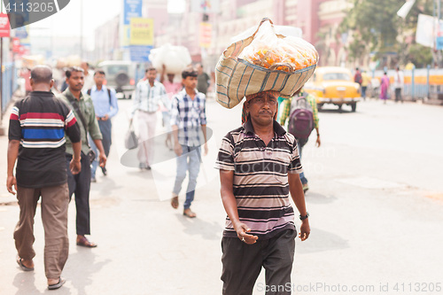 Image of Man carrying flowers