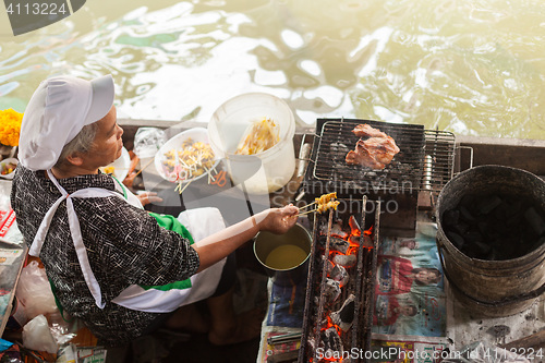 Image of Woman preparing Thai kebab