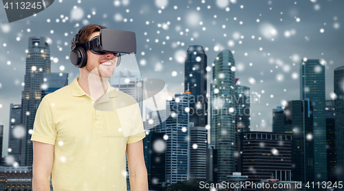 Image of happy man in virtual reality headset or 3d glasses