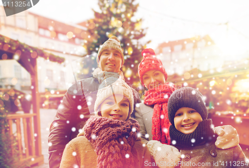 Image of happy family over city christmas tree and snow