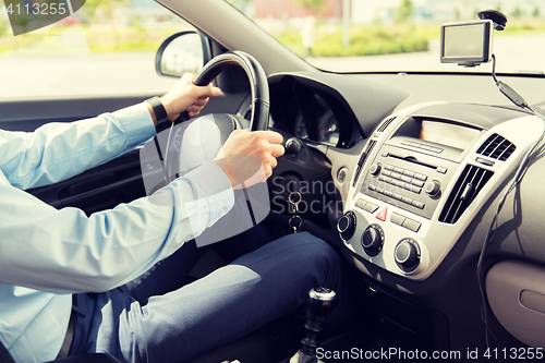 Image of close up of young man driving car