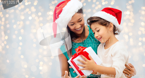 Image of happy mother and child girl with gift box