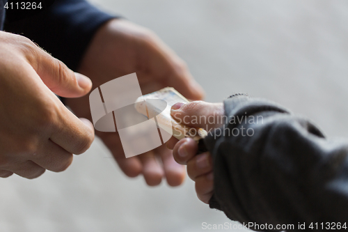 Image of close up of addict buying dose from drug dealer