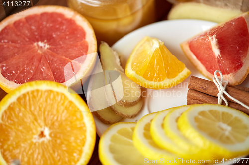 Image of honey, citrus fruits, ginger and cinnamon