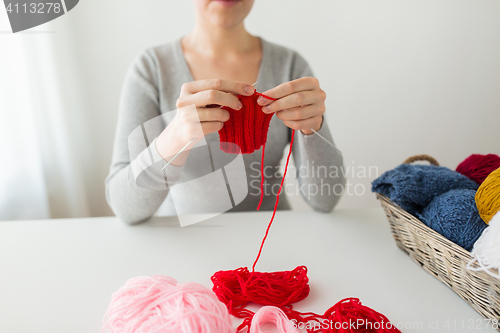 Image of woman hands knitting with needles and yarn