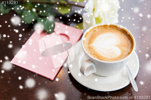 Image of close up of greeting card with heart and coffee