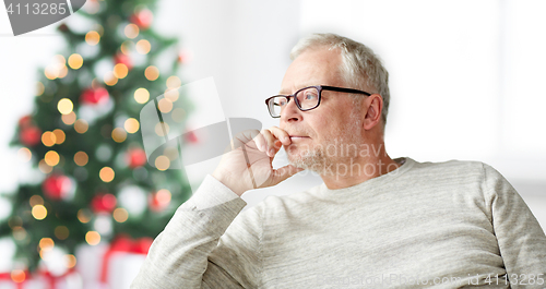 Image of senior man in glasses thinking