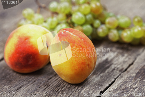 Image of Two peaches and bunch of grapes