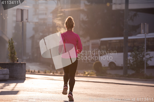 Image of sporty woman jogging on morning