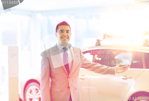 Image of happy man at auto show or car salon