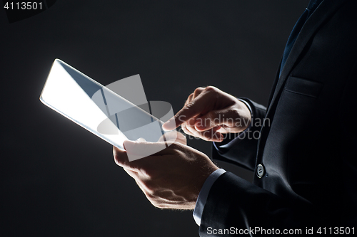 Image of close up of businessman with transparent tablet pc